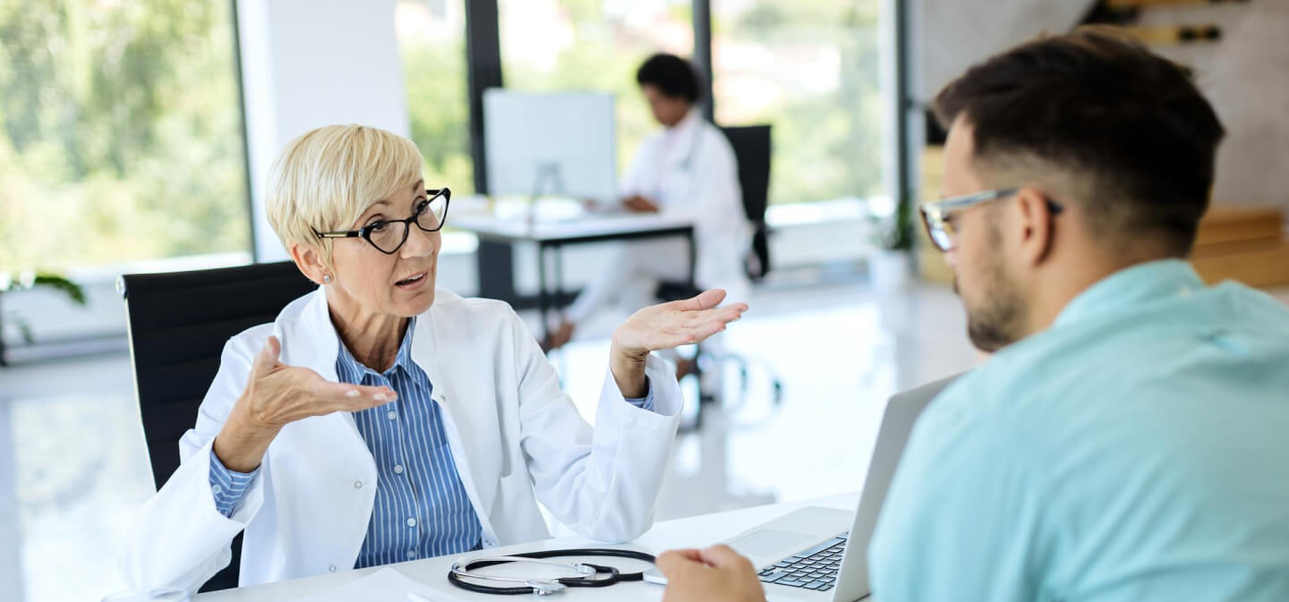 A Female Doctor Talking To A Patient At A Clinic